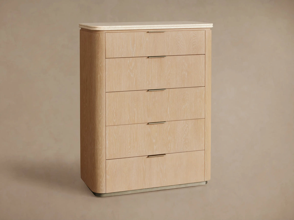 Close-up of Caden dresser, light sand oak veneer with grain, rounded beige stone top. Top drawer closed, second open with pewter pulls.