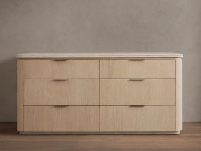 Caden Six-Drawer Dresser in sand finish oak veneer, with a light stone top, pewter edge-pulls, and rounded corners.
