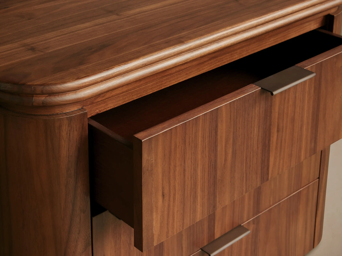 Caden Wood Nightstand in light walnut, featuring three sleek drawers with antique bronze pulls, curved top and plinth.