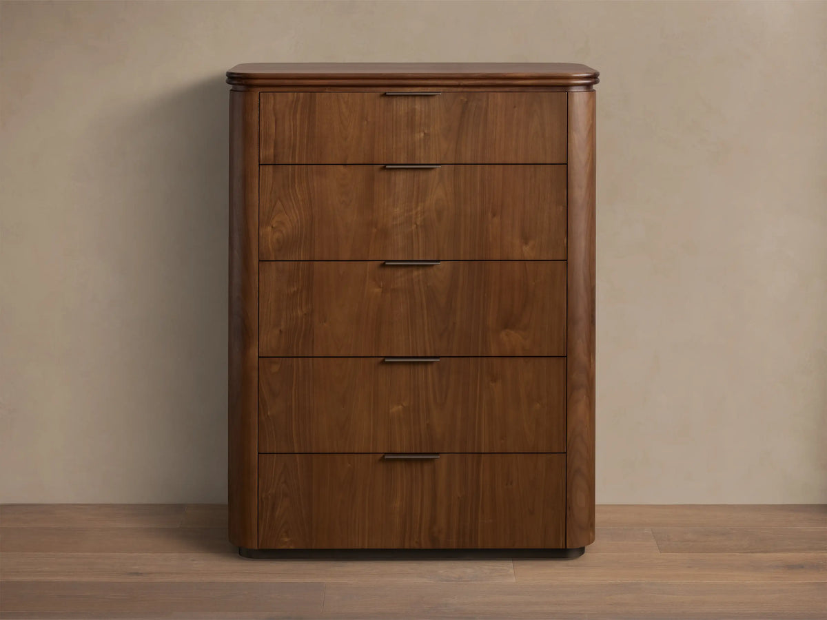 Front view of the walnut Caden Wood Five-Drawer Dresser with five drawers, antique bronze edge-pull hardware, and rounded edges.