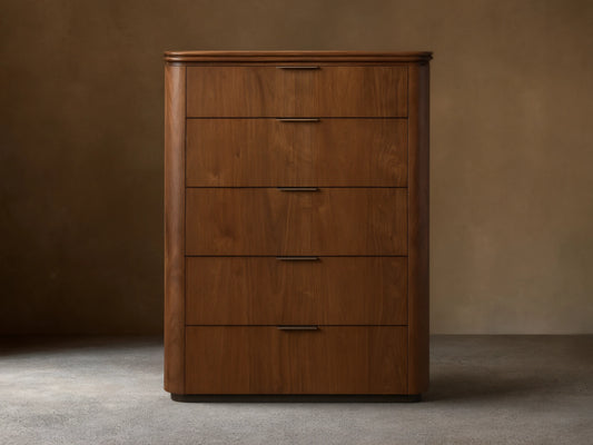 Front view of the walnut Caden Wood Five-Drawer Dresser with five drawers, antique bronze edge-pull hardware, and rounded edges.