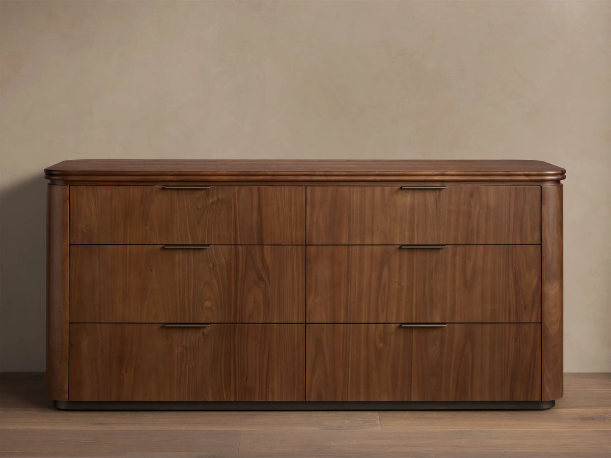 Front view of the Caden Wood Six-Drawer Dresser with a walnut wood finish, rounded top, and dark edge-pull hardware.