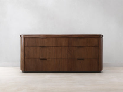 Front view of the Caden Wood Six-Drawer Dresser with a walnut wood finish, rounded top, and dark edge-pull hardware.