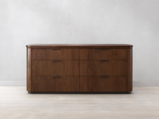 Front view of the Caden Wood Six-Drawer Dresser with a walnut wood finish, rounded top, and dark edge-pull hardware.