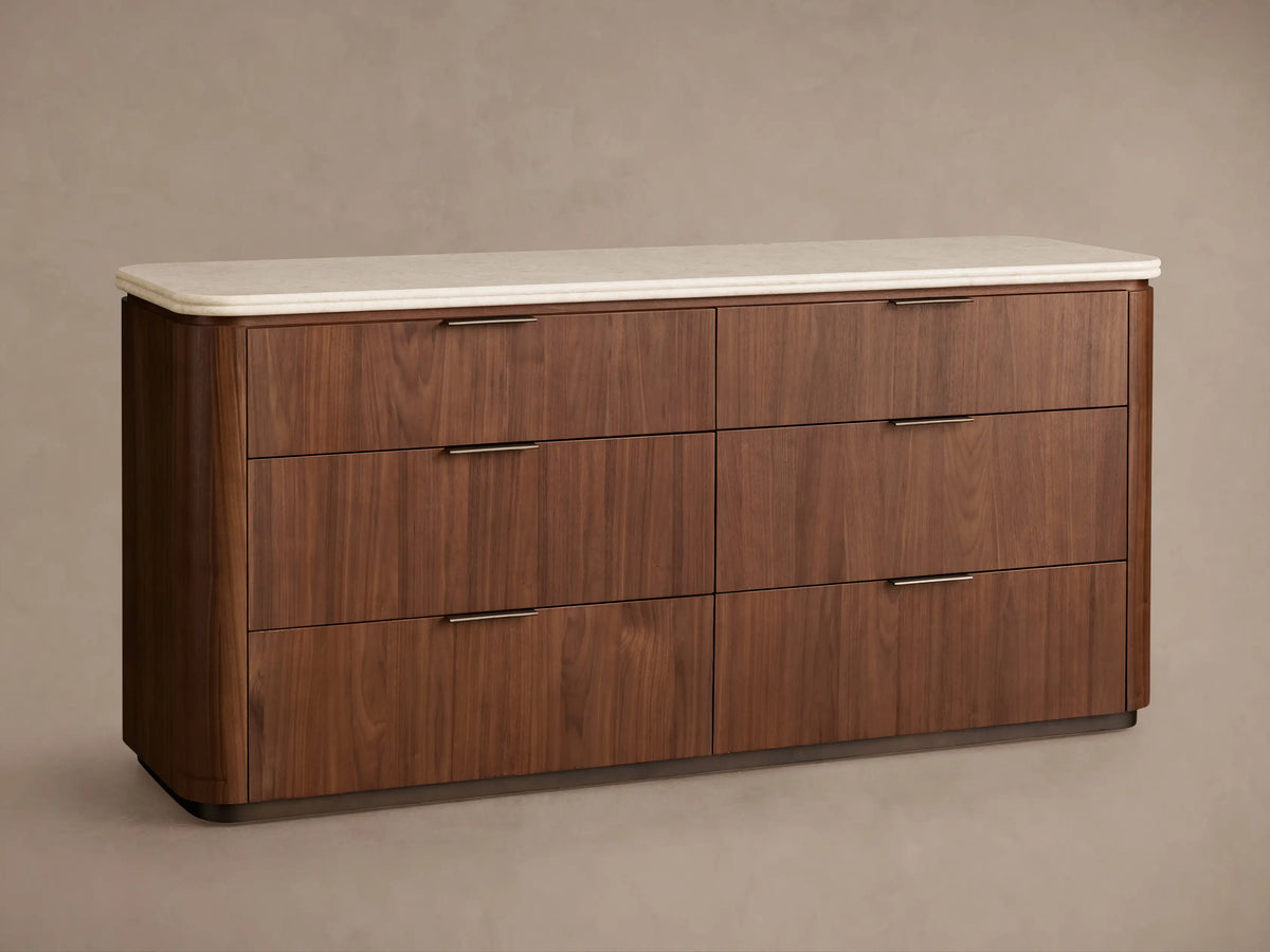 Caden Six-Drawer Dresser in light walnut wood, light stone top. Top drawer open showing antique bronze edge-pull hardware.