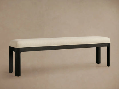 Calista Bench with cream ribbed upholstered top and dark, almost black, oak wood frame and legs, seen from an angle.