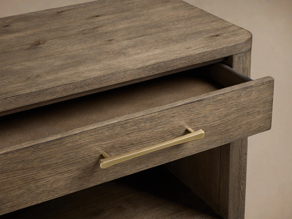 Calista Open Nightstand in veneered oak with a single drawer and open shelf, featuring a satin sheen and brass handle.