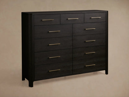 Calista Eleven-Drawer Dresser: Close-up of dark wood with prominent grain and brass bar handles. One drawer is partially open.