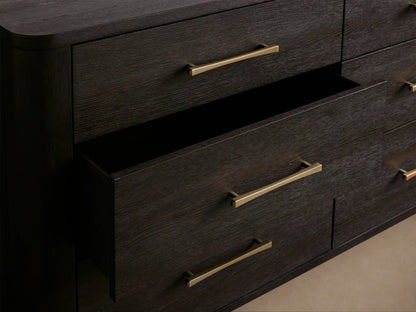 Dark espresso Calista nine-drawer dresser with sleek gold bar pulls, viewed front-on against a light beige wall.