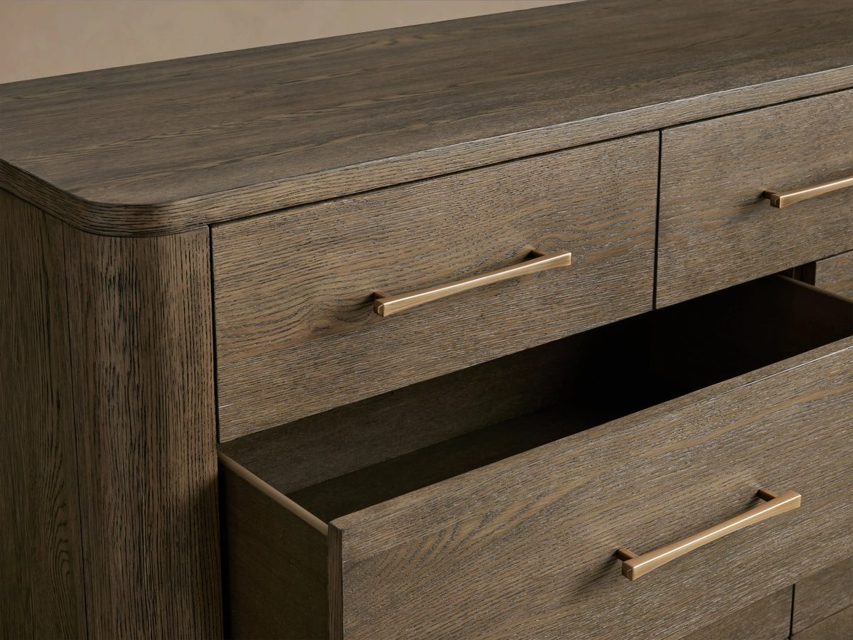 Calista Eleven-Drawer Dresser in oak with a satin sheen, featuring eleven drawers and sleek hardware, two drawers open.
