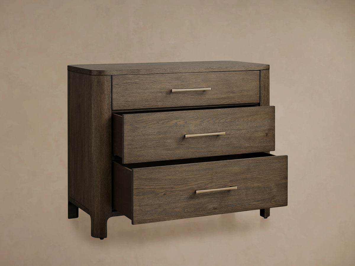 Calista Three-Drawer Chest in veneered oak with a satin sheen, featuring three horizontal drawers with slender metal handles.