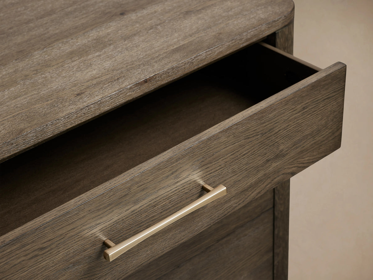 Calista chest with three drawers in dark veneered oak, featuring silver handles, shown with two drawers partially open.