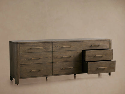 Calista Nine-Drawer Dresser in veneered oak with satin sheen. Three drawers partially open, showing complementing hardware.