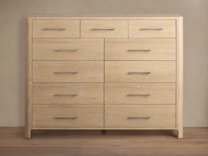 Calista Eleven-Drawer Dresser, light oak wood grain, featuring 3 small top drawers & 8 larger, with silver bar handles.