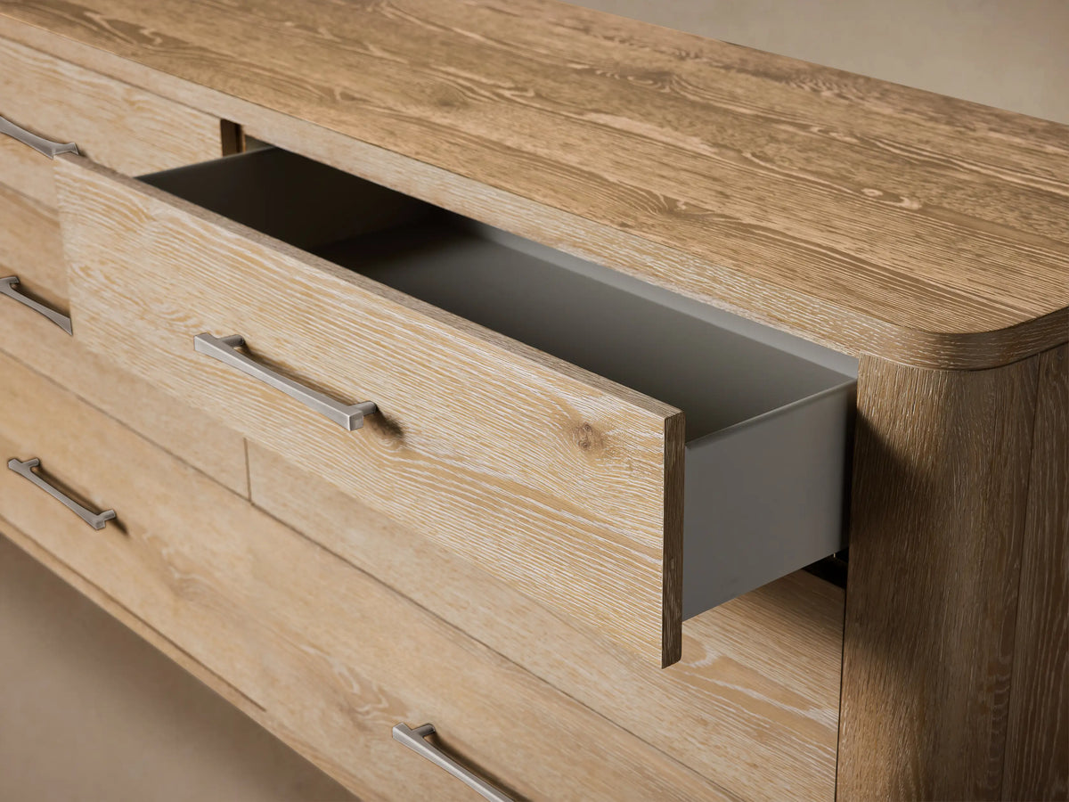 Top-down view of the light-colored Calista Six-Drawer Dresser's wooden surface with prominent grain and rounded corners.