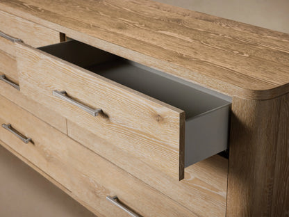 Top-down view of the light-colored Calista Six-Drawer Dresser's wooden surface with prominent grain and rounded corners.