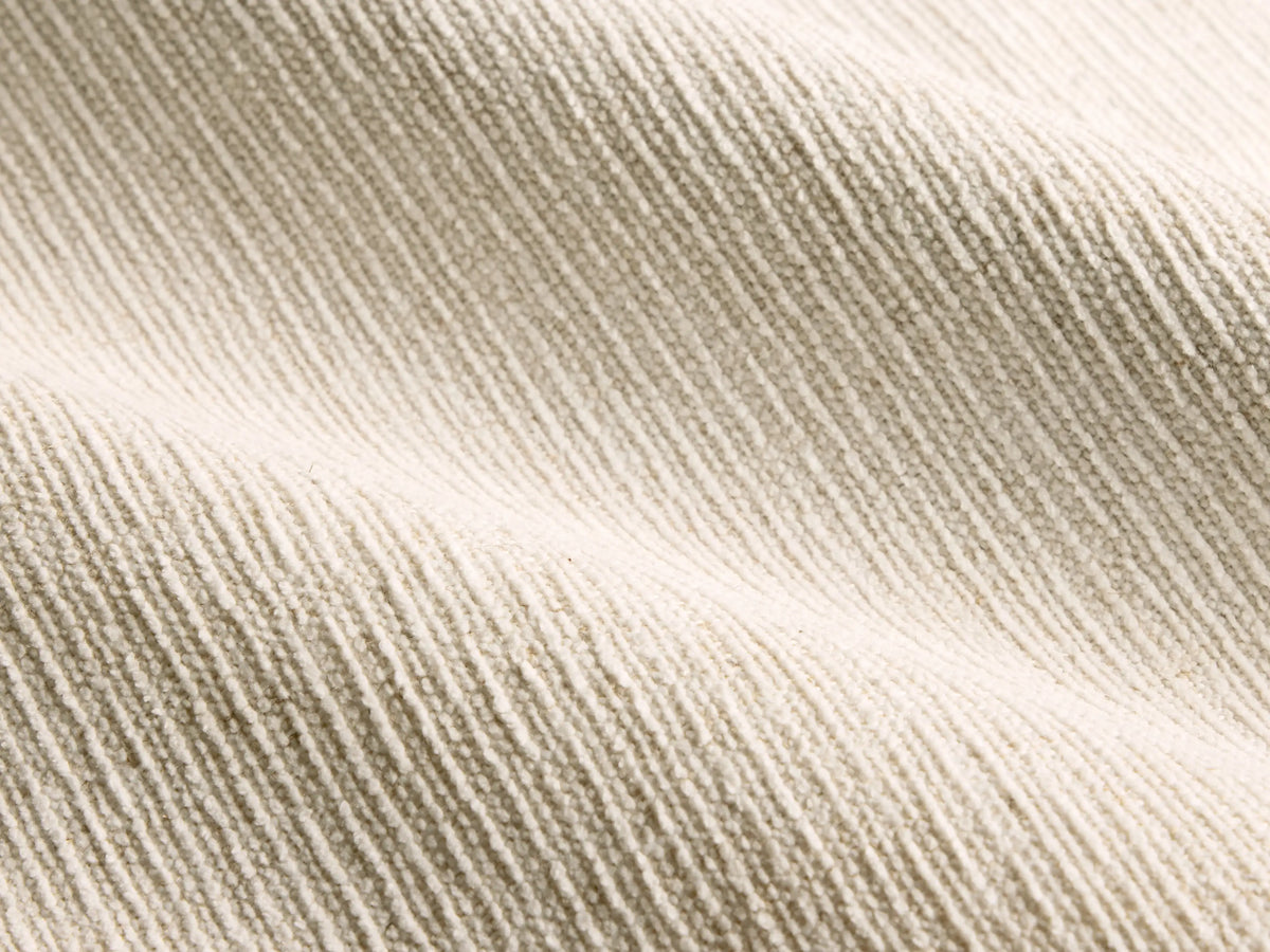 Close-up of the beige ribbed fabric texture on the Calista Bed.