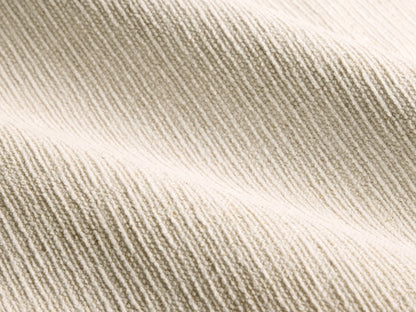 Close-up of the beige ribbed fabric texture on the Calista Bed.