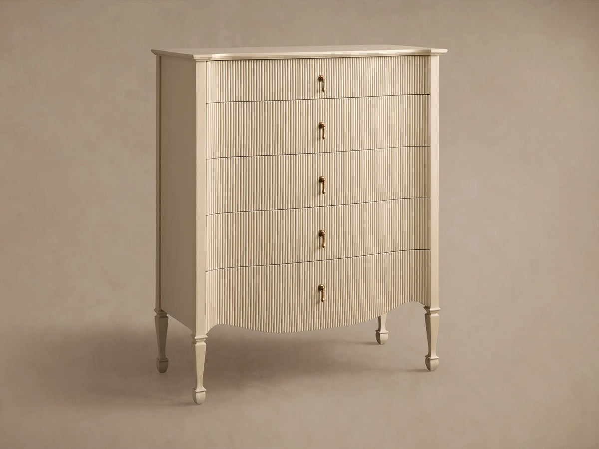 Close-up of Conrad Five-Drawer Dresser, light beige reeded facade. One drawer open, revealing interior. Brass pulls.