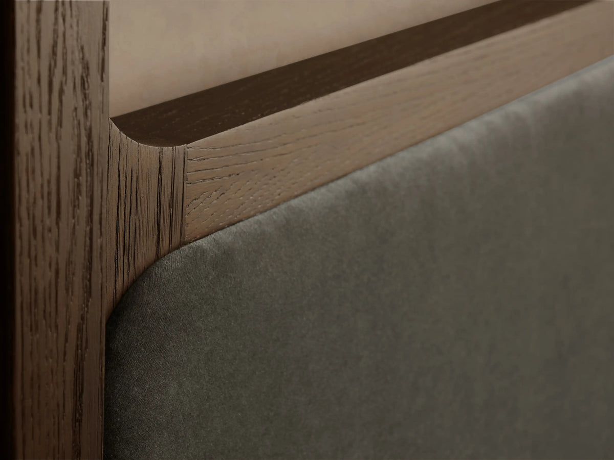 Conley Canopy Bed: A deep olive green upholstered canopy bed with dark oak wood details, featuring crisp white bedding.
