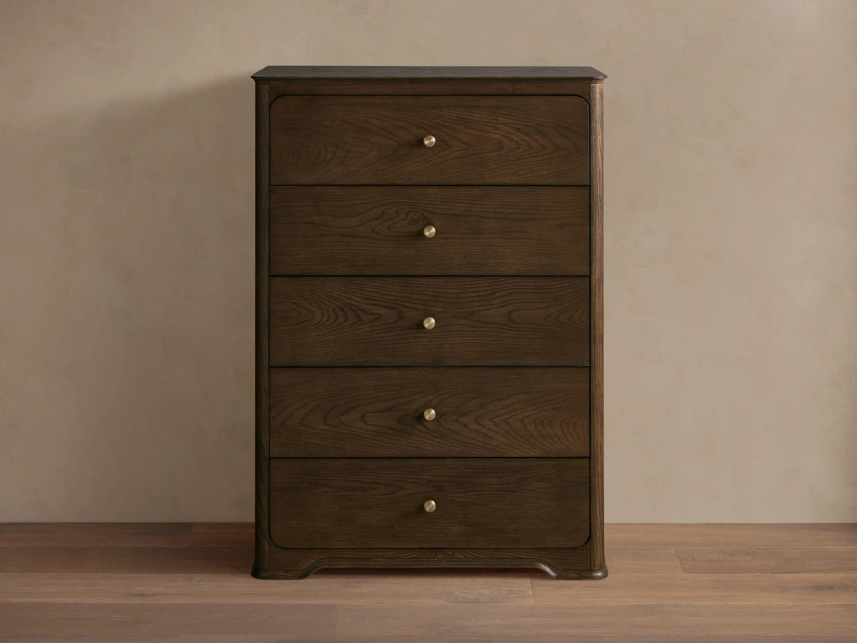 Dark brown oak Conley Five-Drawer Dresser with rounded edges, featuring five drawers each with a champagne brass pull.