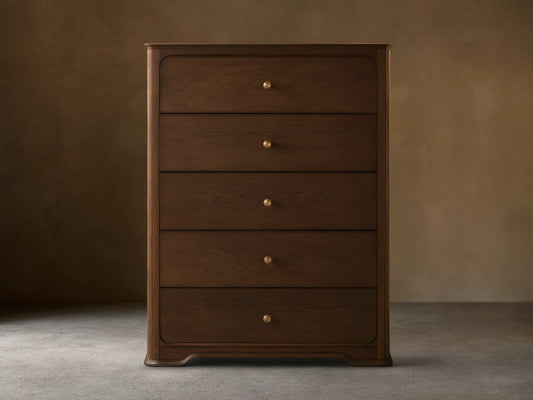 Dark brown oak Conley Five-Drawer Dresser with rounded edges, featuring five drawers each with a champagne brass pull.