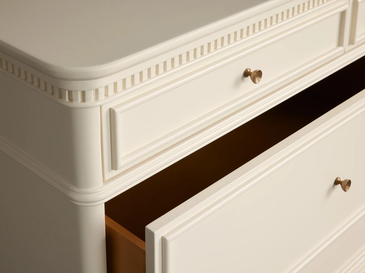 Carlisle Seven-Drawer Dresser in Cr??me birch wood. Features 3 small and 4 large drawers with antique brass pulls.