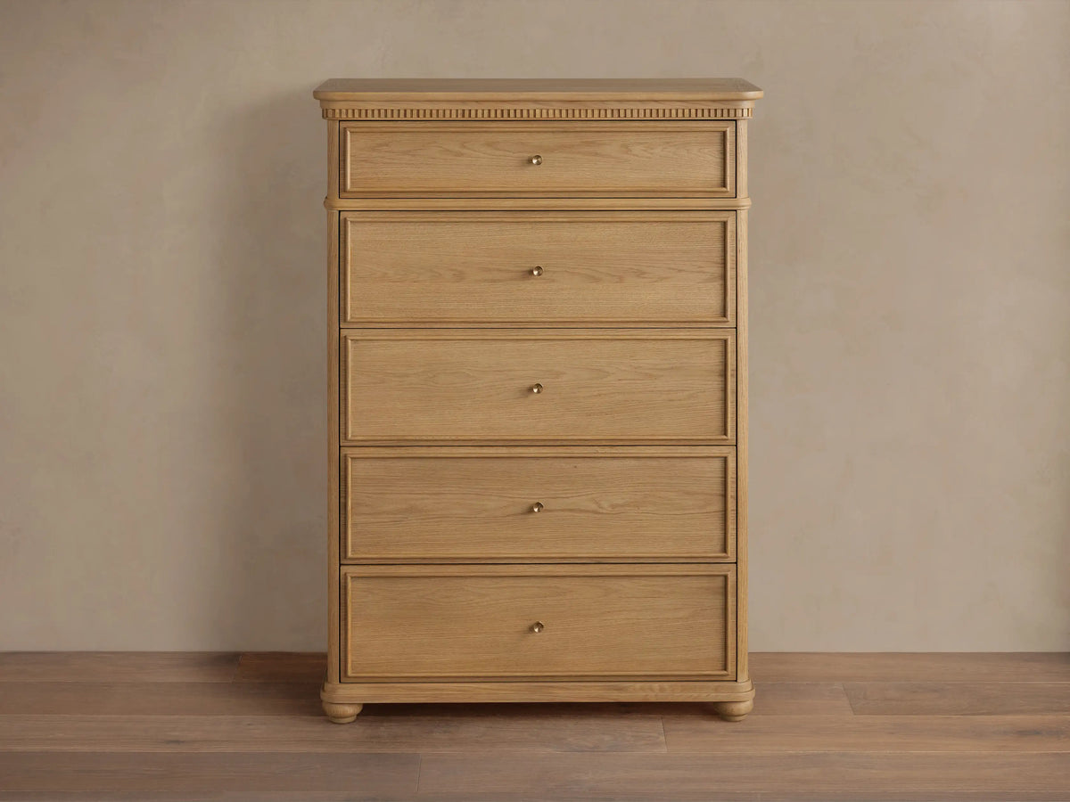 Carlisle Five-Drawer Dresser, light wood with visible grain, 5 drawers, small antique brass pulls, decorative reeding.