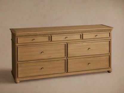Carlisle Seven-Drawer Dresser, light oak wood, 3 small drawers over 4 large, with antique brass pulls and fluted trim.
