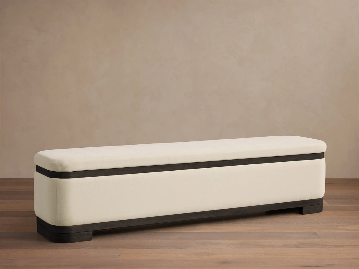 Front view of the Cream upholstered Darien Curved Storage Bench with a dark wood base and trim.