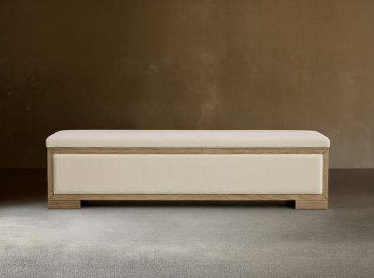 Front view of the Darien Storage Bench, featuring a light oak wood frame and cream upholstered top and front panel.