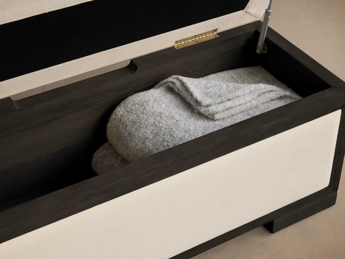 Front view of the Darien Storage Bench with cream upholstery and a dark oak wood frame.