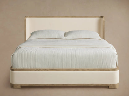 Darien Curved Shelter Bed with low footboard, cream upholstered panels, light oak wood trim, and a curved headboard.