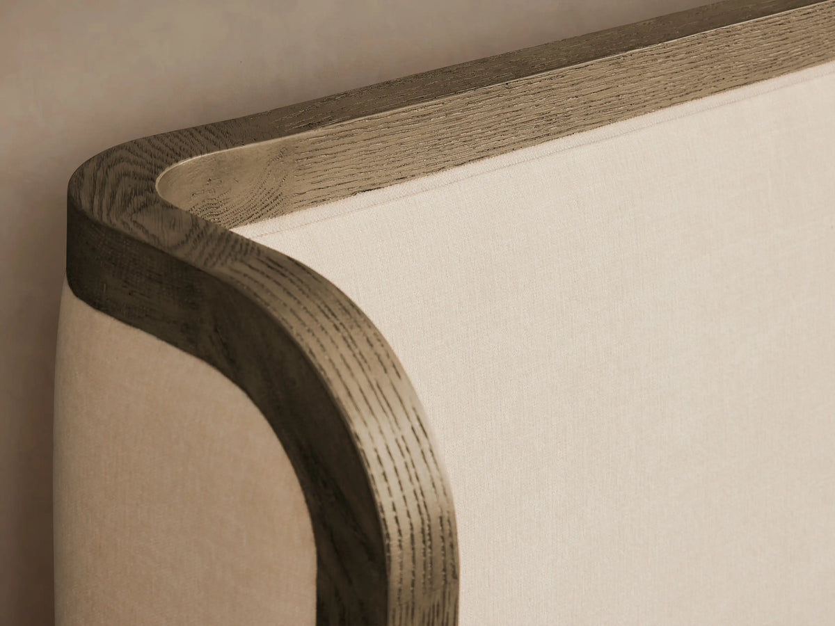 Darien Curved Shelter Bed with low footboard, oak wood frame, and cream upholstered panels, with quilted white bedding.
