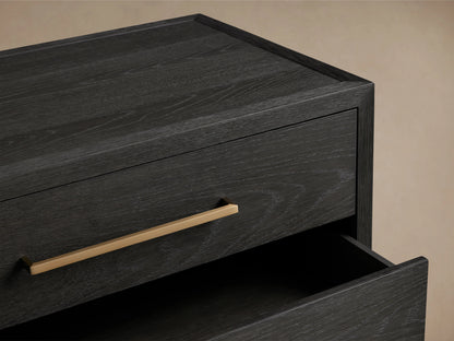 Darwyn Nightstand in dark oak wood with three open drawers, featuring brass pulls, displayed on a neutral background.