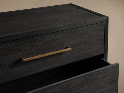 Darwyn Five-Drawer Dresser in dark oak finish showing open top drawer with brass pull handle, against a neutral background.
