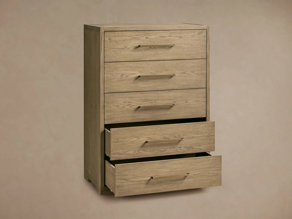Darwyn Five-Drawer Dresser in oak wood with brass pulls, showing two partially open drawers, on a beige background.