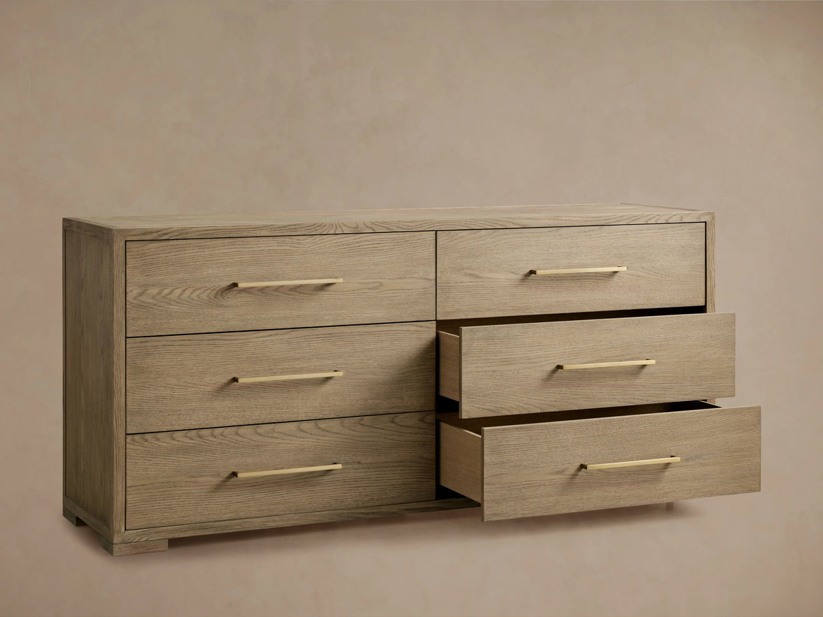 Darwyn Six-Drawer Dresser in oak wood with six brass-handled drawers, three partially open, on a neutral background.