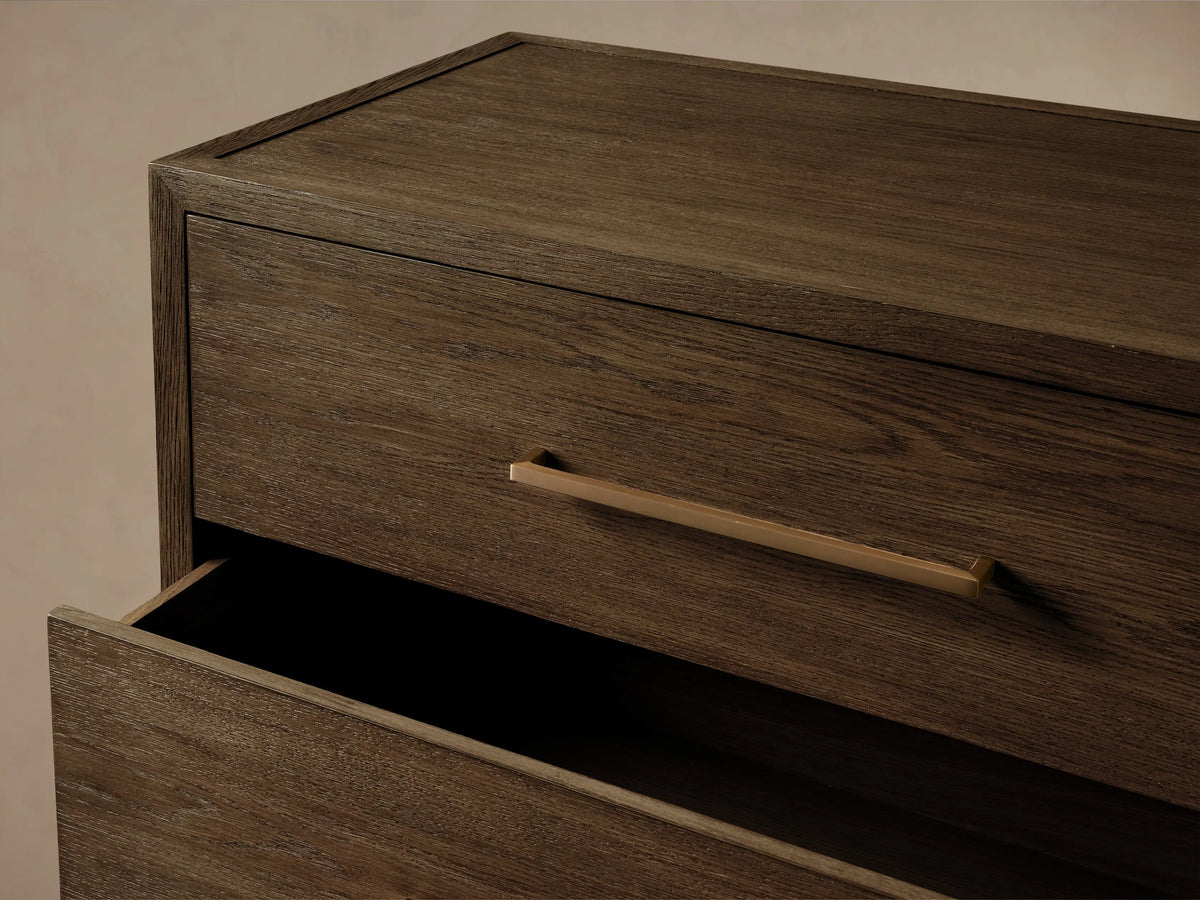 Front view of the dark brown Darien Five-Drawer Dresser, featuring five drawers with natural oak wood grain and brass pull handles.