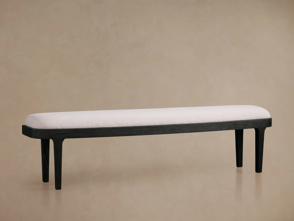 Danny Bench with ebony finish, featuring a cushioned white upholstered seat. It has four sleek, dark wooden legs.
