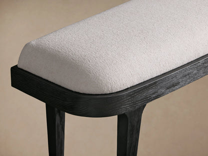 Danny Bench with hand-applied ebony finish, showcasing white fabric upholstery and curved edges on a wooden frame.