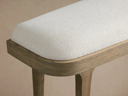 Danny Bench in oak wood with a light brown finish, featuring a cushioned seat upholstered in white premium fabric.