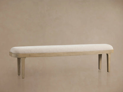 Danny Bench in fawn finish, oak wood frame. Upholstered with light fabric, flat rectangular seat, four tapered legs.