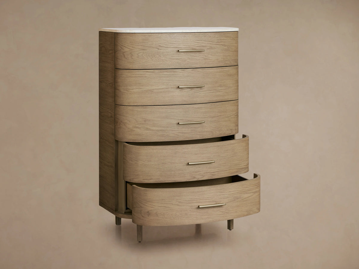 Danny Five-Drawer Dresser made of oak with fawn finish. Features five drawers with brass pulls, white marble top, and soft-close glides.