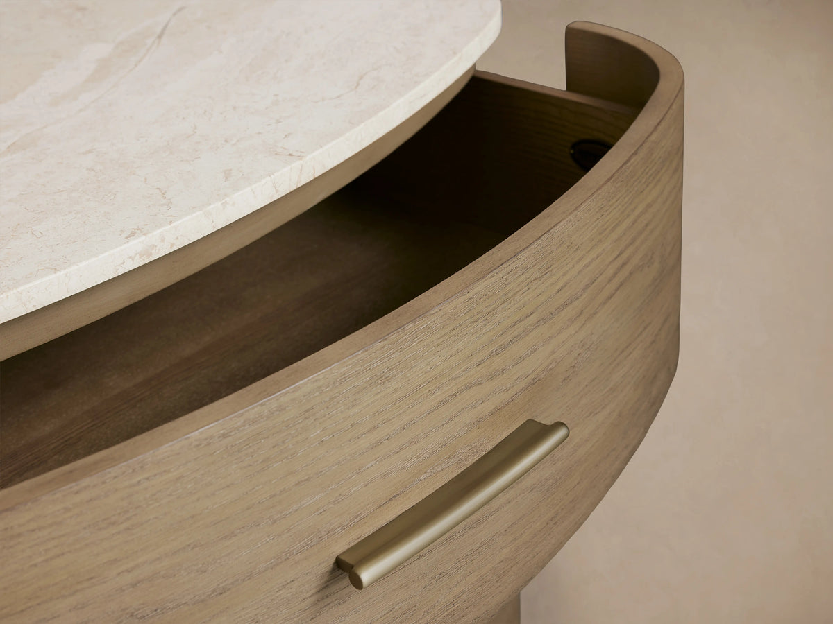 Danny Five-Drawer Dresser in oak wood with fawn finish, features brass drawer pulls and a cream marble top on soft-close glides.