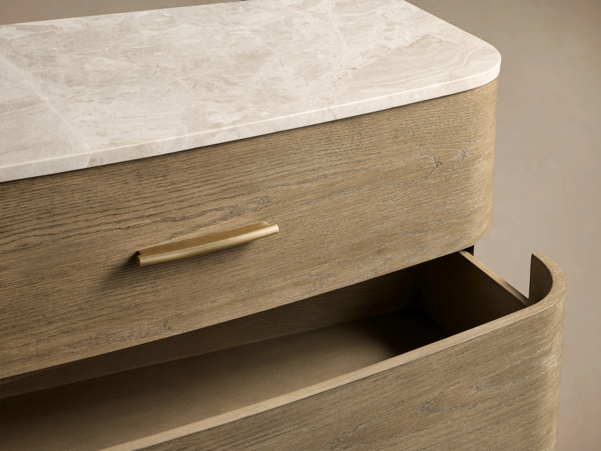 Danny Six-Drawer Dresser in oak with a fawn finish, featuring a white marble top and six drawers with brass pulls.