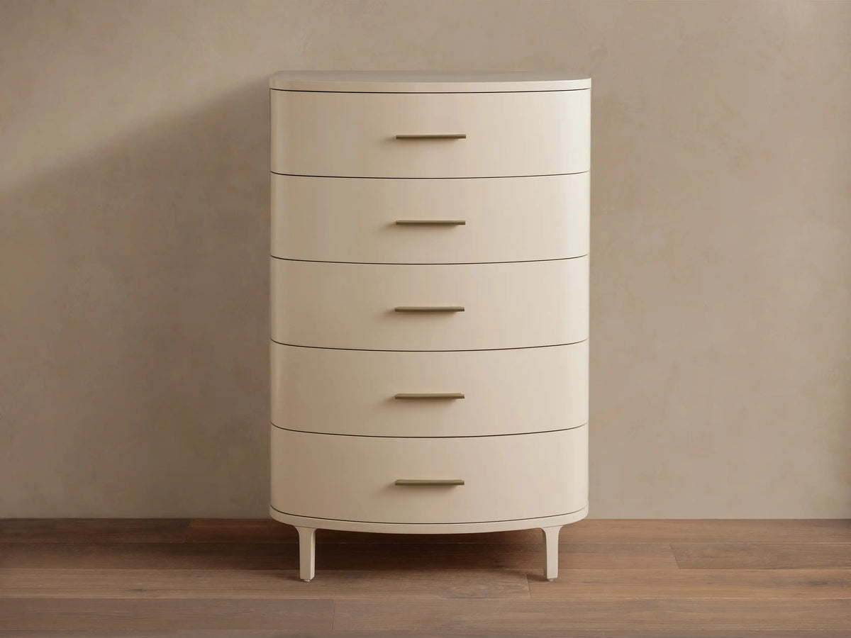 Danny Five-Drawer Dresser in Fumo: light cream finish, five drawers with horizontal brass pulls, rounded edges, on wood.