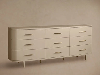 Danny Nine-Drawer Dresser in fumo, a light beige, with rounded corners, 9 drawers, and horizontal brass pulls.