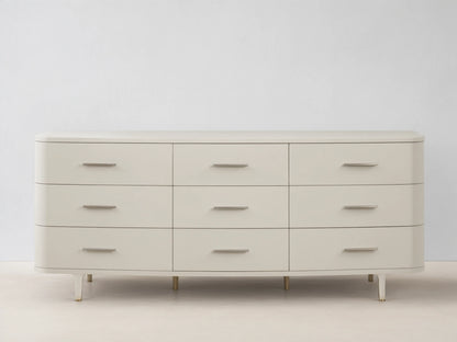 Danny Nine-Drawer Dresser in fumo, a light beige, with rounded corners, 9 drawers, and horizontal brass pulls.