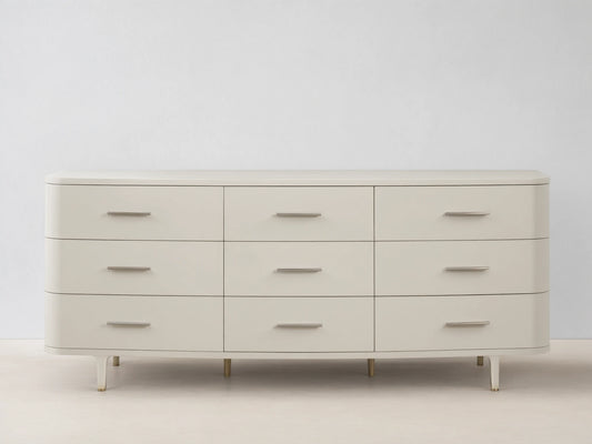 Danny Nine-Drawer Dresser in fumo, a light beige, with rounded corners, 9 drawers, and horizontal brass pulls.
